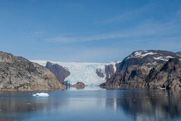 Prins Christian Sund Greenland mountain fjord with floating ice and shore iceberg on a summer day