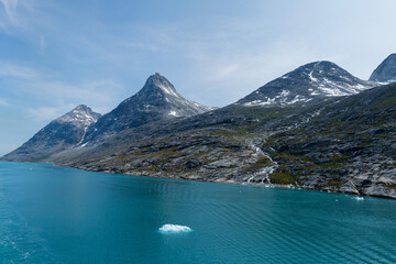 Obraz premium Prins Christian Sund Greenland mountain fjord with floating ice and shore iceberg on a summer day