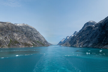 Prins Christian Sund Greenland mountain fjord with floating ice and shore iceberg on a summer day