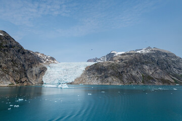 Prins Christian Sund Greenland mountain fjord with floating ice and shore iceberg on a summer day
