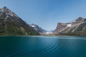 Prins Christian Sund Greenland mountain fjord with floating ice and shore iceberg on a summer day