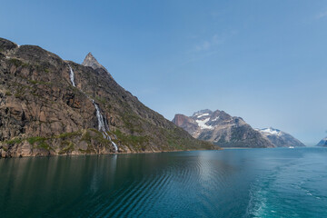 Prins Christian Sund Greenland mountain fjord with floating ice and shore iceberg on a summer day