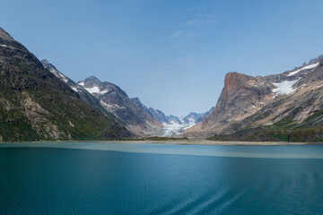 Prins Christian Sund Greenland mountain fjord with floating ice and shore iceberg on a summer day
