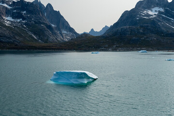 Prins Christian Sund Greenland mountain fjord with floating ice and shore iceberg on a summer day