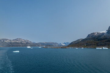 Prins Christian Sund Greenland mountain fjord with floating ice and shore iceberg on a summer day