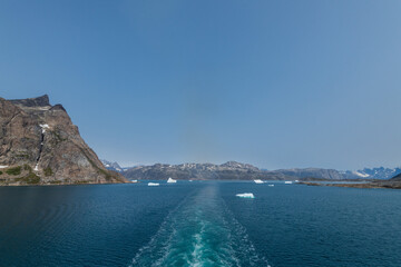 Prins Christian Sund Greenland mountain fjord with floating ice and shore iceberg on a summer day