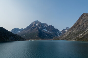 Prins Christian Sund Greenland mountain fjord with floating ice and shore iceberg on a summer day