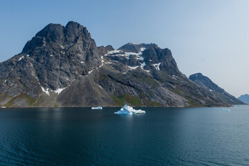 Prins Christian Sund Greenland mountain fjord with floating ice and shore iceberg on a summer day