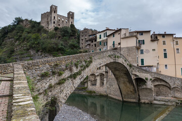 Fototapeta premium Medieval arched stone bridge against Old town in Dolceacqua, Italy