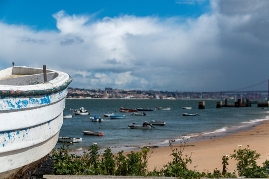 Wooden boats on the banks of the Tajo River, at its mouth, in front of the city of Lisbon in Trafaria