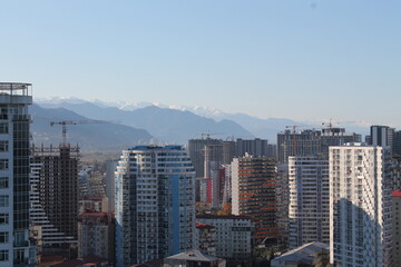 Obraz premium Multi-level chaotic development in Batumi, Georgia, on a sunny day. The variety of architectural styles and high-rise buildings forms a unique urban landscape 