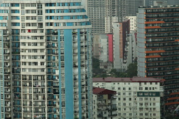 Obraz premium Multi-level chaotic development in Batumi, Georgia, rainy day. The variety of architectural styles and high-rise buildings form a unique urban landscape.