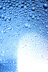 Blue Rain Bubbles Drops Running down a Window on a Wet Day Abstract Background