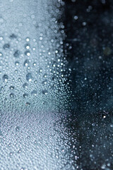 Blue Rain Bubbles Drops Running down a Window on a Wet Day Abstract Background