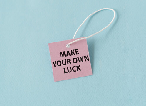 Make Your Own Luck text quote on a pink card, Business Concept on Blue Background. - Powered by Adobe