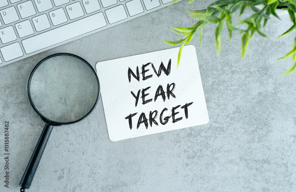 Poster new year target text on paper note pad with keyboard.