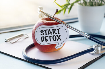 Start Detox on white sticky paper on an apple, Motivational Words Quotes Concept