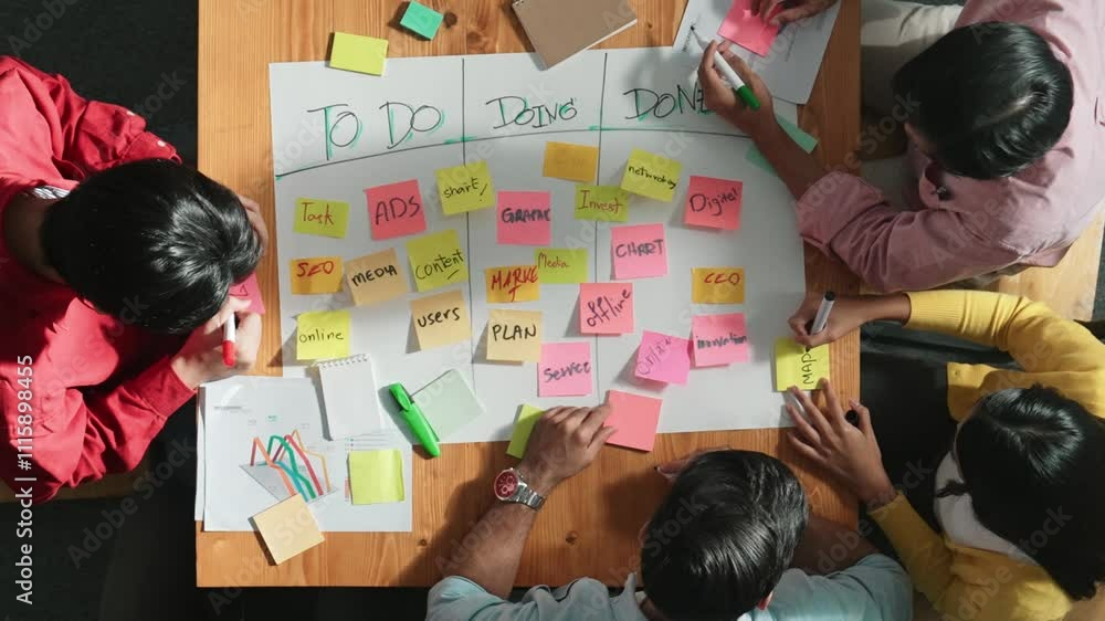 Aufkleber top view of people writing and making scrum task board while writing marketing and planning strategy