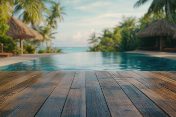 A serene poolside view with wooden decking and tropical surroundings.