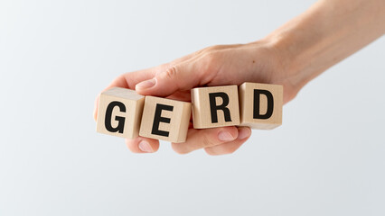 Wooden block form the word GERD with stethoscope on the doctor's desktop, medical concept