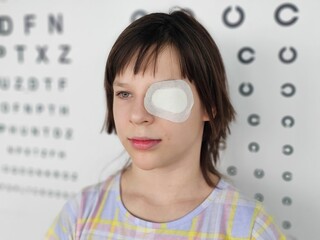 Child undergoing eye patch treatment in an optometry clinic for vision improvement concept