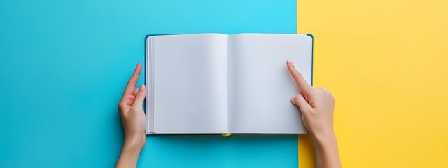 A person's hand holding an open spiral notebook, with blank paper on the left side and space for text in front of it.