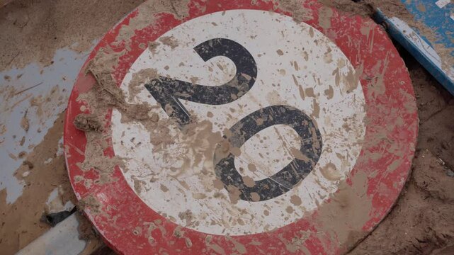Broken road sign with mud in the DANA of Valencia