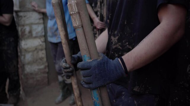 Man holding cleaning tools in the dana of Valencia