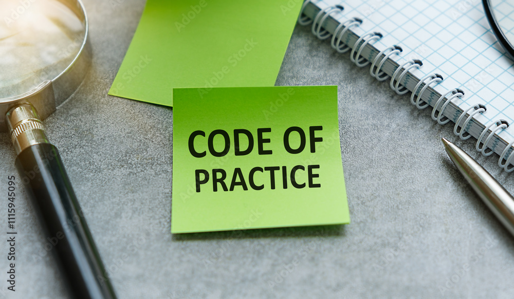 Poster code of practice text written on a notebook with pencils