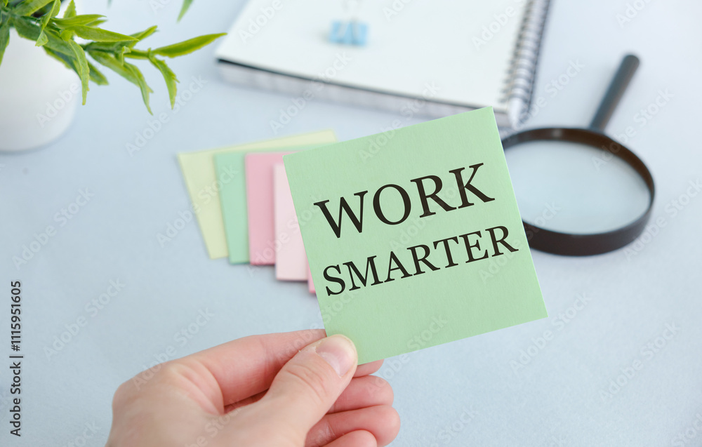 Poster man showing work smarter text on notepad.