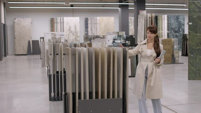 Woman choosing tile samples in a showroom