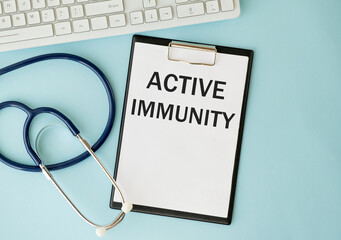 The text ACTIVE IMMUNITY is written on a white sheet by a doctor's hand.