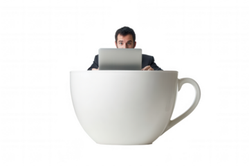 Caucasian male adult working on laptop inside giant coffee cup.