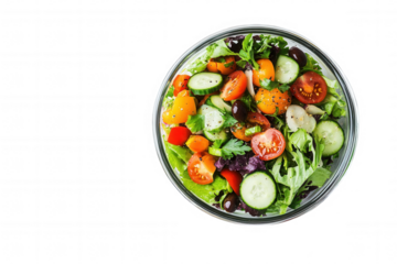 Isolated on a transparent background. Fresh vegetable salad with tomatoes, cucumbers, and olives in glass bowl.