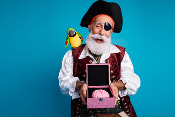 Photo portrait of bearded pirate man hold brain box wear hallooween costume isolated on blue color...