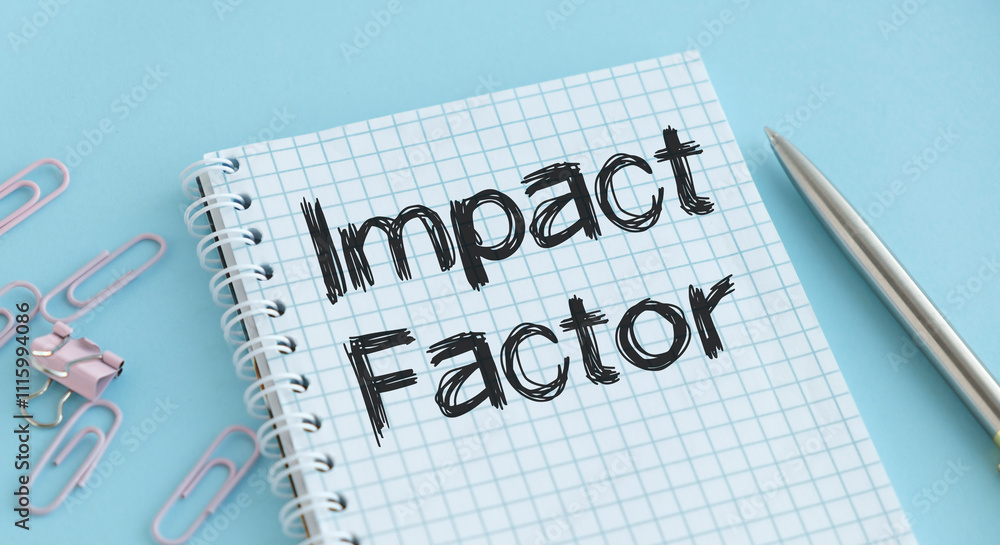 Poster impact factor open notebook with text on a wooden table near the calculator.