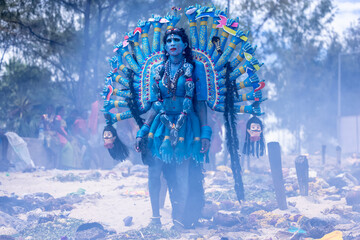 Kulasai Dasara, Portrait of indian male with painted face and dressed as hindu goddess kali to...