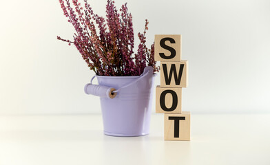 swot. Wooden letters on the office desk. Business and money investment background