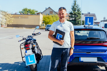 Motorcycle driving school instructor with training equipment outdoors