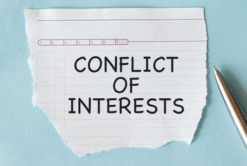 Torn paper with text CONFLICT OF INTERESTS on blue background with pen aside