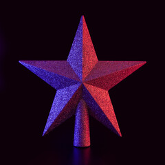 Obraz premium christmas star decoration with neon glowing colors on black background