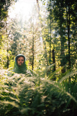 Person Hidden Among Lush Forest Ferns