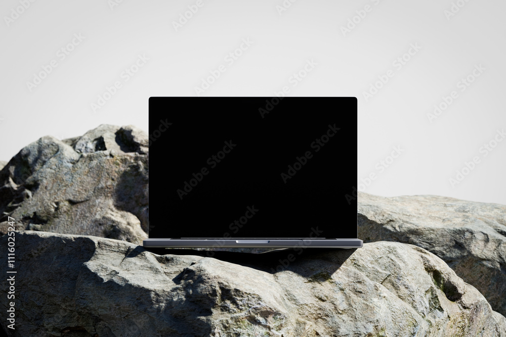 Wall mural scene with a opened laptop with a blank screen on the rock