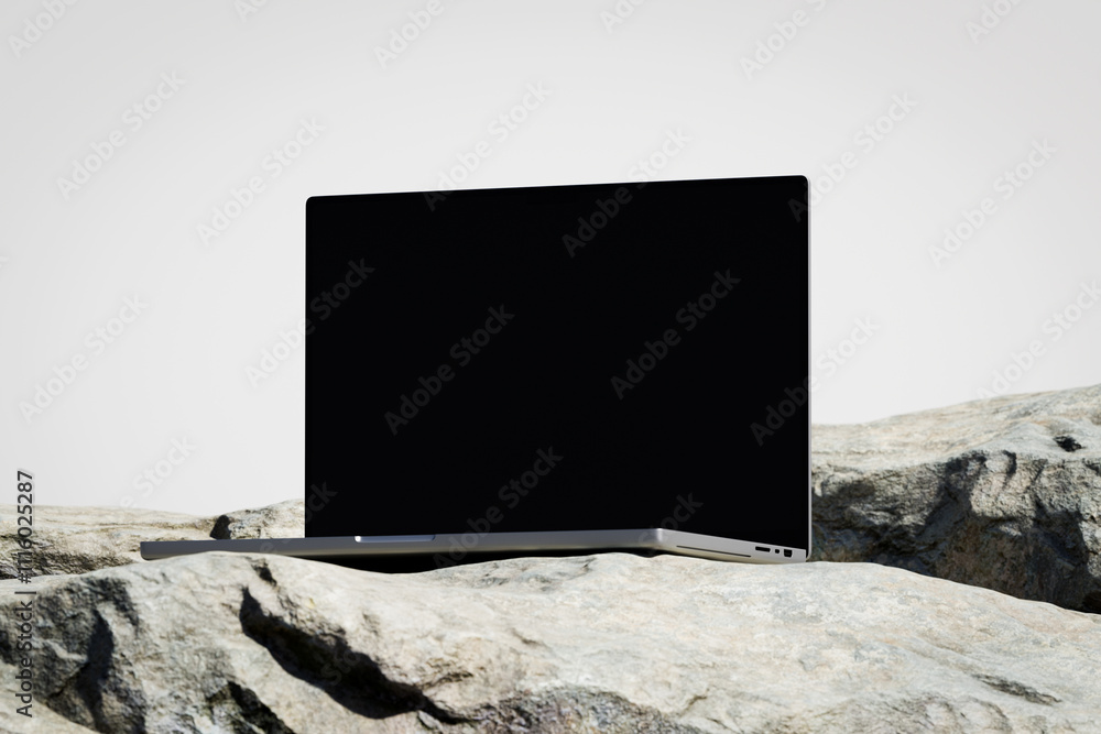Wall mural scene with a opened laptop with a blank screen on the rock