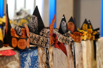 An array of Indonesian batik shirts and batik cloth hangs on the racks, displaying a variety of patterns and colors.