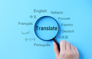 Translation and Multilingual Communication Concept. A magnifying glass highlights the word...