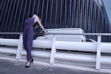 woman in fashionable clothes in trendy color future dusk of the year against architecture