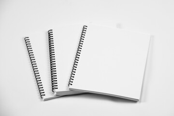 Set of closed spiral bound books, isolated on white background