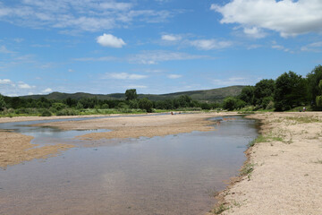 
Landscape of the Los Sauces River in the town of Nono, Córdoba, Argentina. Tourists on the river.