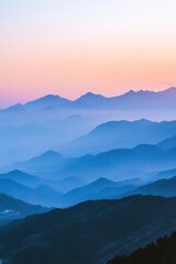 Fototapeta premium Serene mountain landscape at dusk, showcasing layers of hills and mist.
